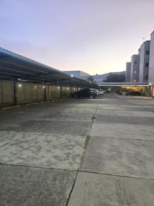 a parking lot with cars parked next to a building at Hotel y Villas Gran Vía, Tultitlán in Mexico City