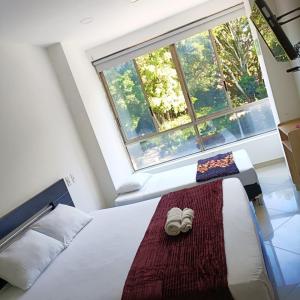 Postel nebo postele na pokoji v ubytování Hotel Laureles Park
