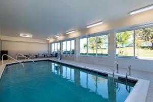 a swimming pool with blue water in a building at TownePlace Suites by Marriott Brentwood in Brentwood