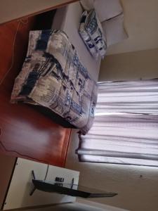 a view of a window in a room with a newspaper at Quietcozy in Polokwane