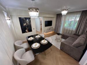 a living room with a table and a couch at VLH Apartments in Constanţa