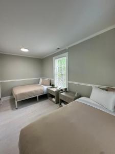 a bedroom with a large bed and a window at Family Home Pool HotTub Near Lighthouse Point Park in New Haven