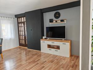 a living room with a flat screen tv on a cabinet at Holiday House ''Villa Flora'' in Šibenik