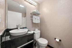 a bathroom with a sink and a toilet and a mirror at Studio 6 Extended Stay - Roswell, GA - Atlanta in Roswell +30 photos