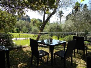 a table and chairs with a view of a field at Albergo Blueline in Tellaro