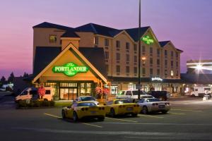 a group of cars parked in a parking lot in front of a hotel at The Portlander Inn and Marketplace in Portland