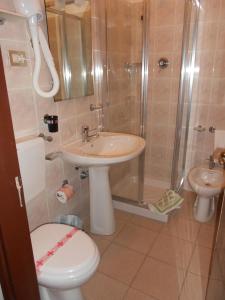 a bathroom with a toilet and a sink and a shower at Albergo Blueline in Tellaro