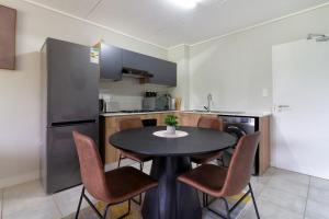 a kitchen with a table and chairs in a kitchen at Spacious 1Br in Westlands in Nairobi +77 photos