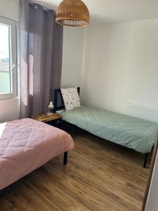 a room with two beds in it with a window at Villa d'Aneta in Le Poët