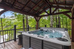 a hot tub on a deck with a pergola at Lakefront Home-Stunning Views-Hot Tub, 3100 sqft! in Wakefield