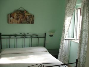 En eller flere senge i et værelse på Agriturismo Fara del Falco
