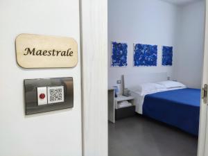 a room with a bed and a door with a clock at 41 Parallelo - Comfort rooms in Bari +27 photos