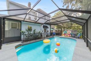 a swimming pool with an arcade over it at Martin B- historic district apt with pool in Ocala