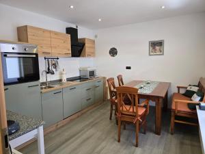 a kitchen and dining room with a table and chairs at Ferienhaus Doris in Heimbach