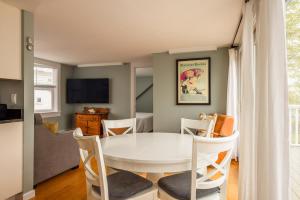 a dining room with a white table and chairs at Eagle House Motel in Rockport