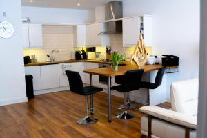 a kitchen with a wooden table and black chairs at Cleave House - Modern 3 Bed and 2 Bath House - Sleeps 6 - Contractors Corporate and Family Friendly in Farnborough