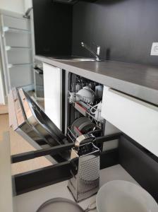 a dishwasher under a counter in a kitchen at Apart Loris in Hart im Zillertal +17 photos