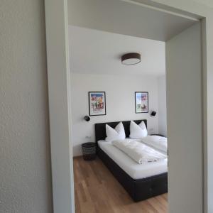 a bedroom with a bed and a mirror at Apart Loris in Hart im Zillertal