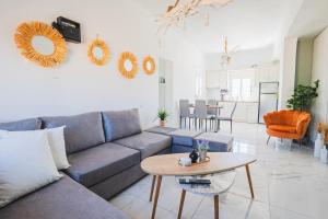 a living room with a couch and a table at Stone Villa Afiartis in Karpathos Town