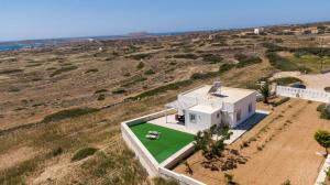 an aerial view of a white house with a green lawn at Stone Villa Afiartis in Karpathos Town