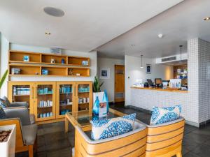 a living room with a couch and a table at Lagoon Shoreline Penthouse in Cape Town