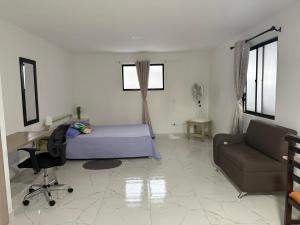 a bedroom with a bed and a desk and a couch at Apartamento en Envigado in Envigado