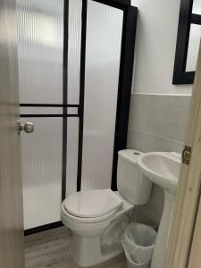 a bathroom with a toilet and a sink at Apartamento en Envigado in Envigado
