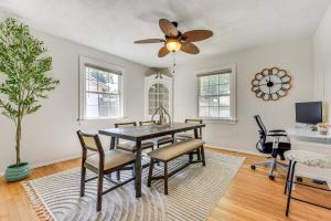 a dining room with a table and chairs and a ceiling fan at 4 Mi to Dtwn Jacksonville Chic Home with Porch! in Jacksonville