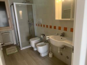 a bathroom with a toilet and a sink and a shower at Residence Villa al Lido in Brenzone sul Garda +69 photos