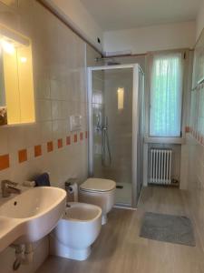 a bathroom with two sinks and a toilet and a shower at Residence Villa al Lido in Brenzone sul Garda