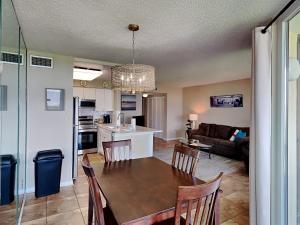 a kitchen and living room with a table and chairs at Santa Rosa Dunes #1022 in Pensacola Beach