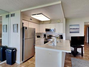 a kitchen with a refrigerator and a counter top at Santa Rosa Dunes #1022 in Pensacola Beach +20 photos