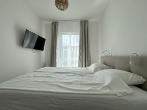 Postel nebo postele na pokoji v ubytování Apartament Mika Let's Sea 73 Tuż przy plaży, klimatyzacja, basen