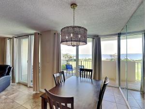 a dining room with a table and views of the ocean at Santa Rosa Dunes #1022 in Pensacola Beach