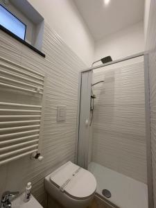 a small bathroom with a toilet and a shower at Don Mimì Casa Vacanza in Torre del Greco +32 photos