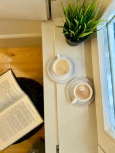 a table with two cups of coffee and a plant at Santa Justa Bedrooms in Lisbon