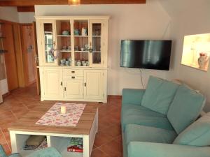 a living room with a couch and a coffee table at Ferienhaus Dea in Krummhörn