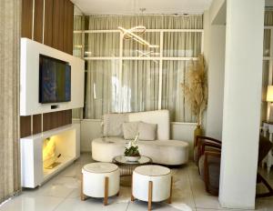 a living room with a couch and a fireplace at Hotel Ibicui in Rosário do Sul