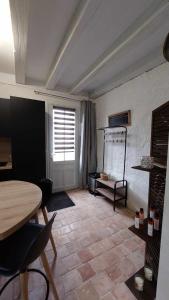 a living room with a table and a window at Gîte Elendil - Esprit Champêtre in Chambon +13 photos