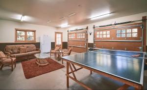 a living room with a ping pong table in it at Large Private Home, Pool, Hot Tub, Sauna, Games in Mille-Isles