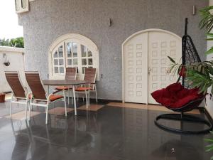 a dining room with a table and chairs at The Manor in Lomé