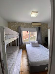 Ένα ή περισσότερα κρεβάτια σε δωμάτιο στο Apartamento Temporada