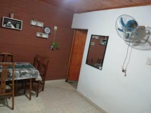 a dining room with a table and a refrigerator at Acuario Departamentos in Presidencia Roque Sáenz Peña