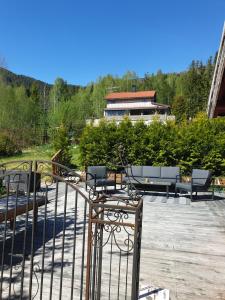 a group of chairs and tables on a patio at Holidays 4 rooms in Gol