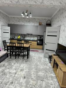 a kitchen and dining room with a table and chairs at Issyk-Kul, Sary-Oi, Atlantis in Chetkoysu