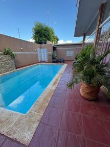 a swimming pool in the backyard of a house at Apart Hotel BRIANA in Puerto Iguazú