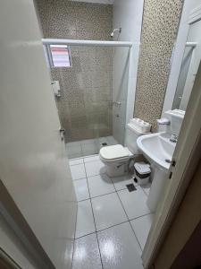 a bathroom with a toilet and a sink at Apart Hotel BRIANA in Puerto Iguazú +17 photos