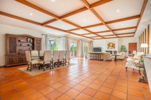 an open living room with a table and chairs at Solar de Prado River Front in Vila de Prado