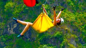 a girl flying in the air with a parachute at Hotel La Casa de Francois in San Agustín