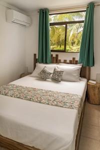 a bedroom with a large bed with green curtains at Drift Away Lodge CR in Santa Cruz +99 photos